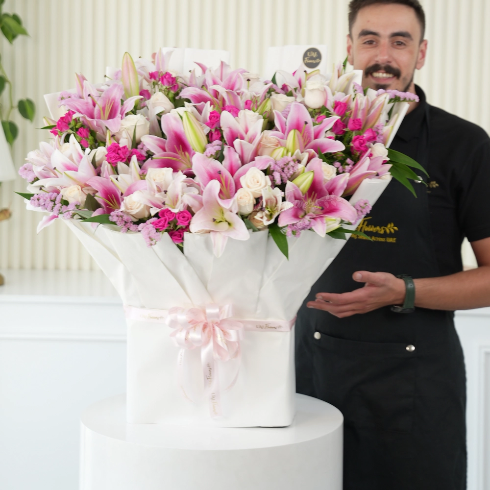 Bouquet of 10 pink lilies, 30 white roses, 10 pink spray roses with green fillers tied with ribbons.