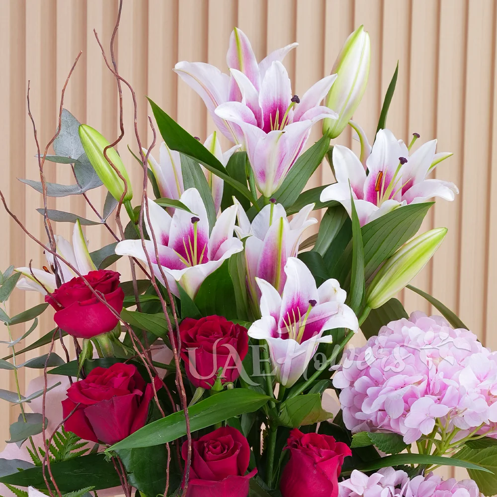 2 pink hydrangeas, 2 pink lilies, and 8 red roses