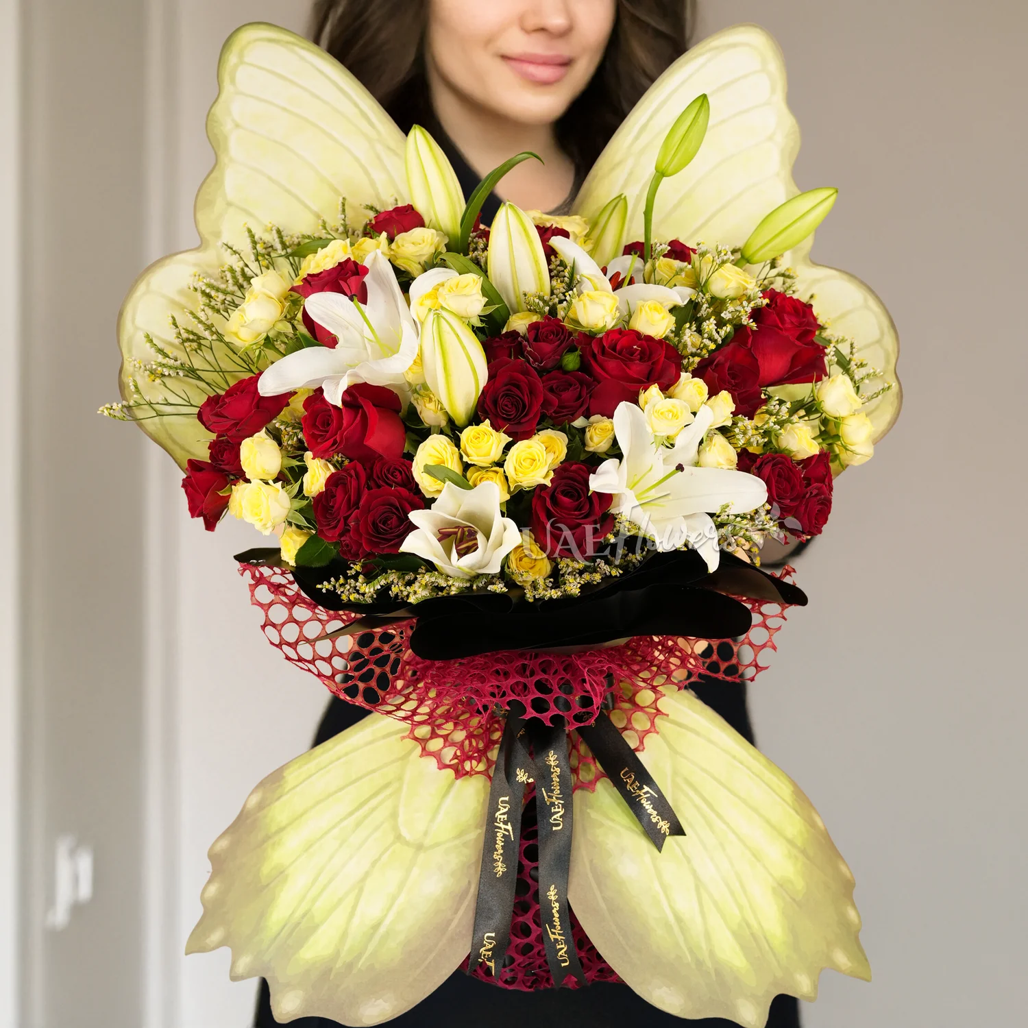 2 white lilies, 5 red roses, 3 red spray roses, and 5 yellow spray roses