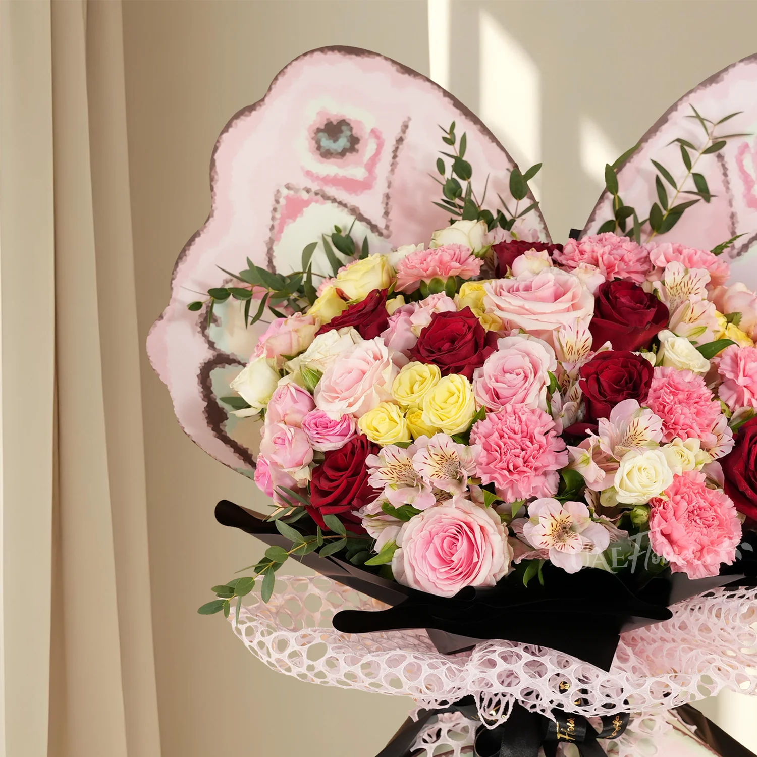 7 red roses, 5 pink roses, 8 pink carnations, 2 pink, 2 white, 2 yellow spray roses, 3 pink alstroemerias