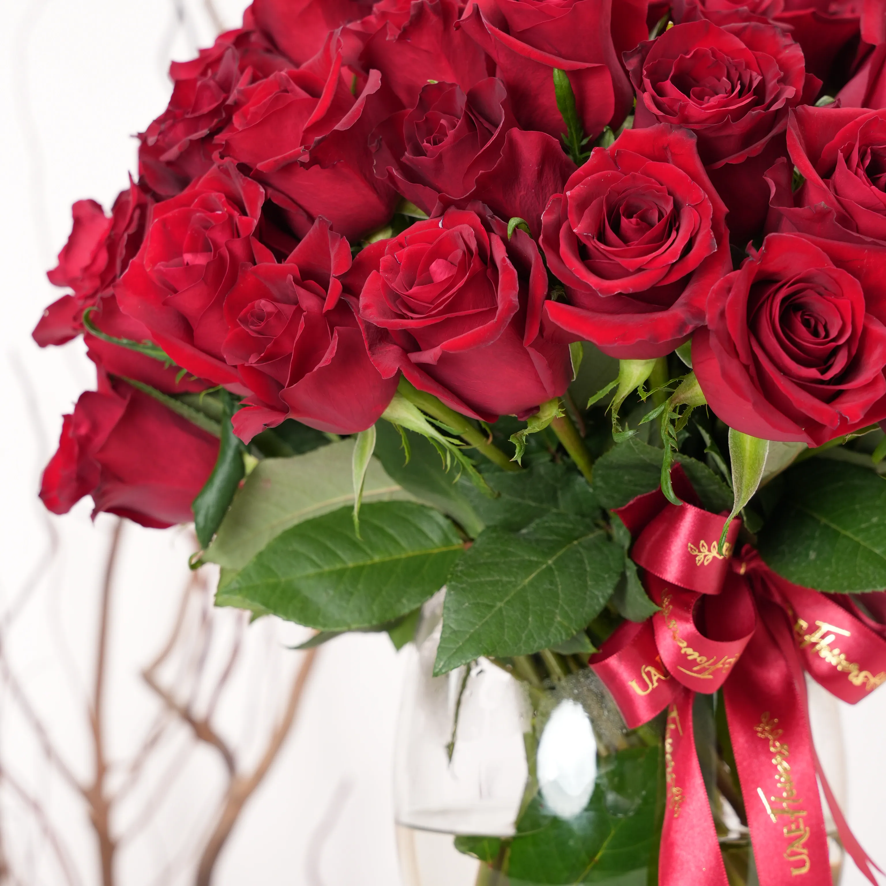 vase arrangement of 40 red roses with green fillers