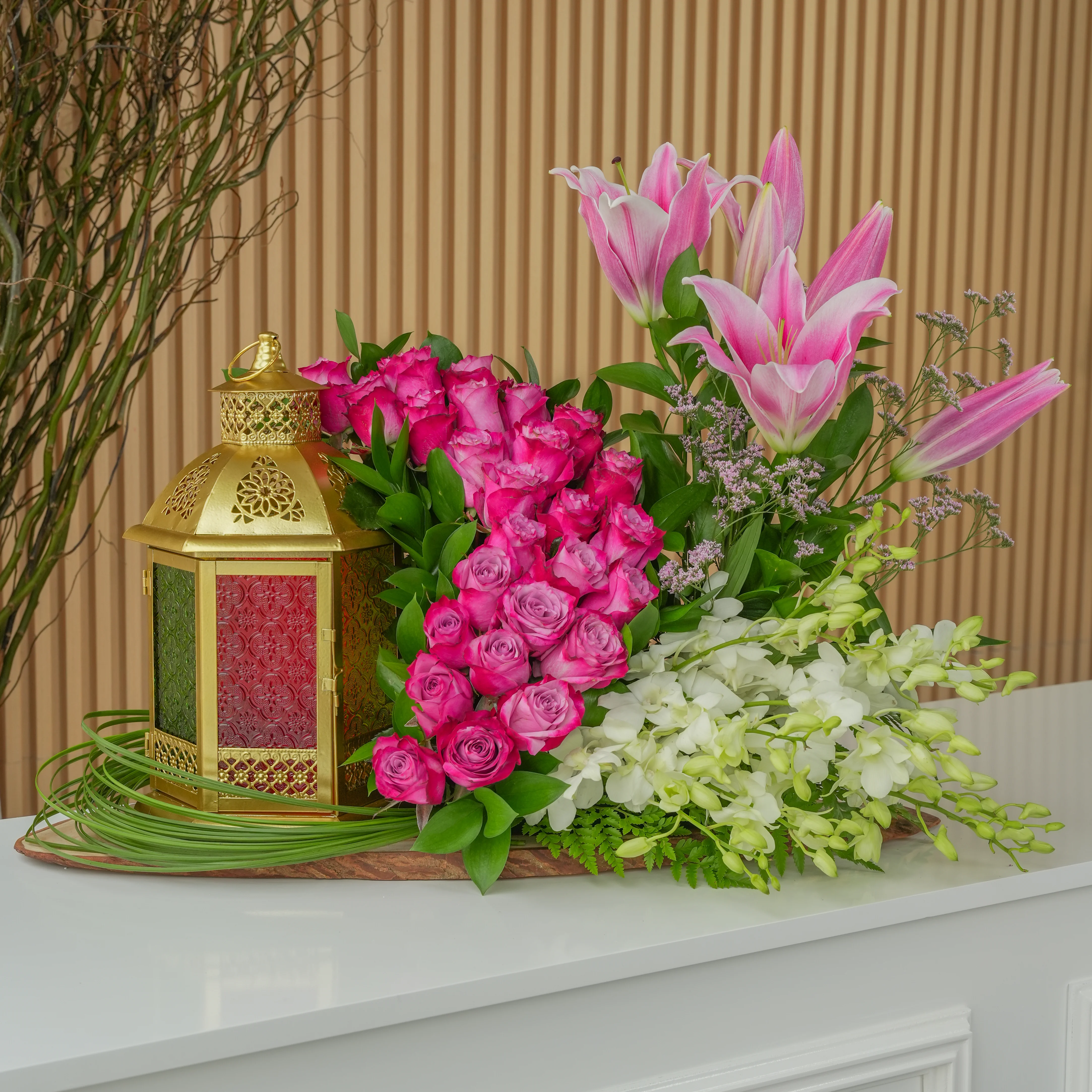 30 purple roses, 1 pink lily stem, 10 white orchids, and a gold lantern.