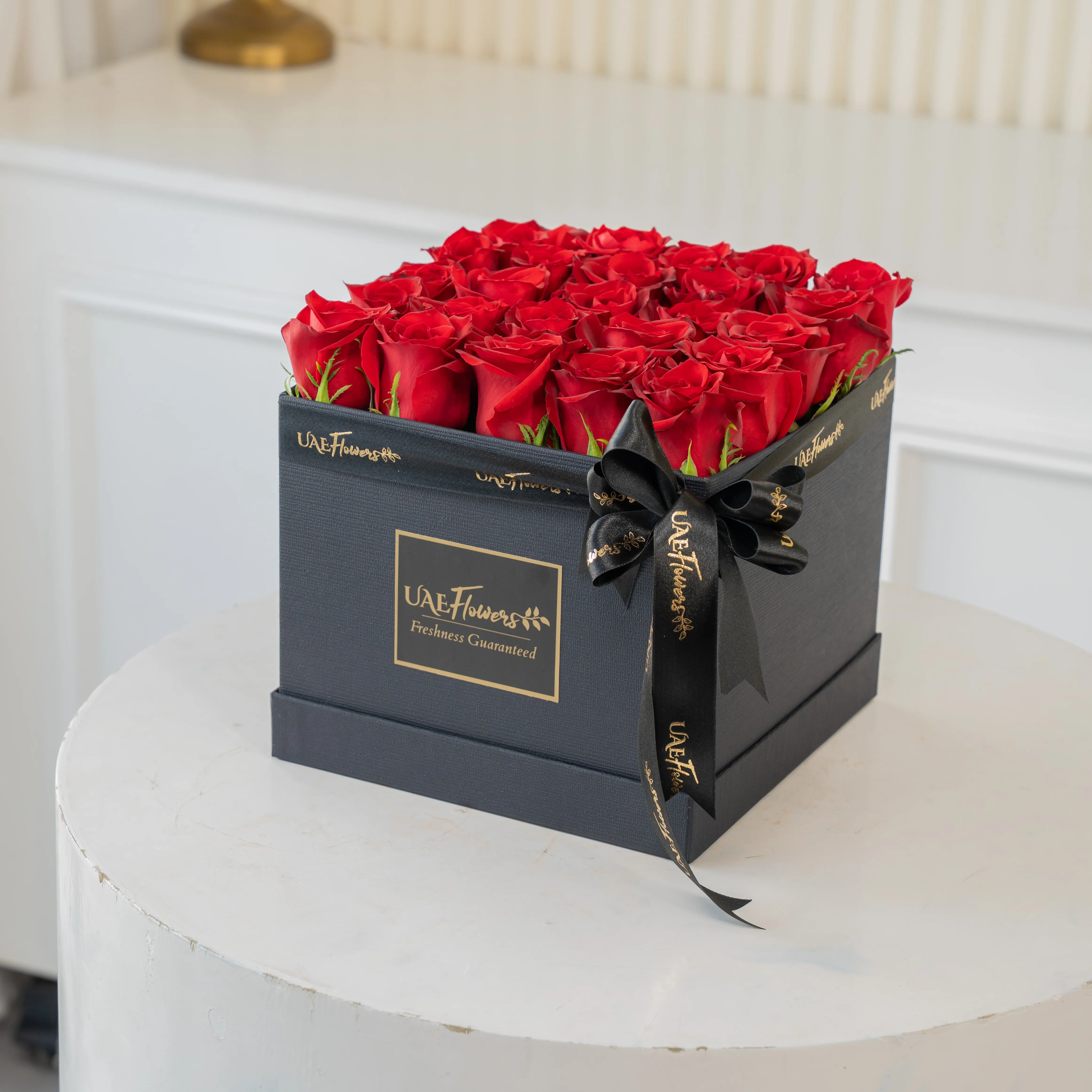 20 red roses in a round box.