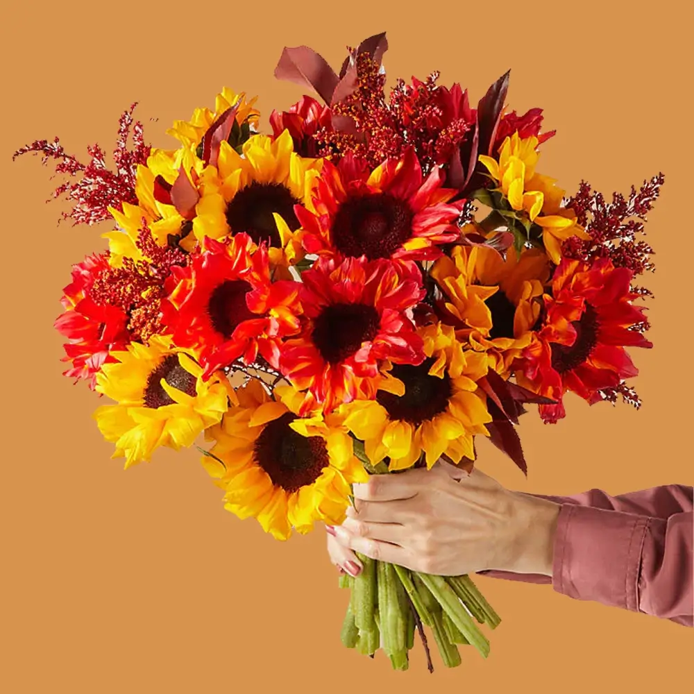 A bouquet consisting of 8 yellow sunflowers and 8 red color sprayed sunflowers, along with red sprayed color fillers, all tied with a ribbon