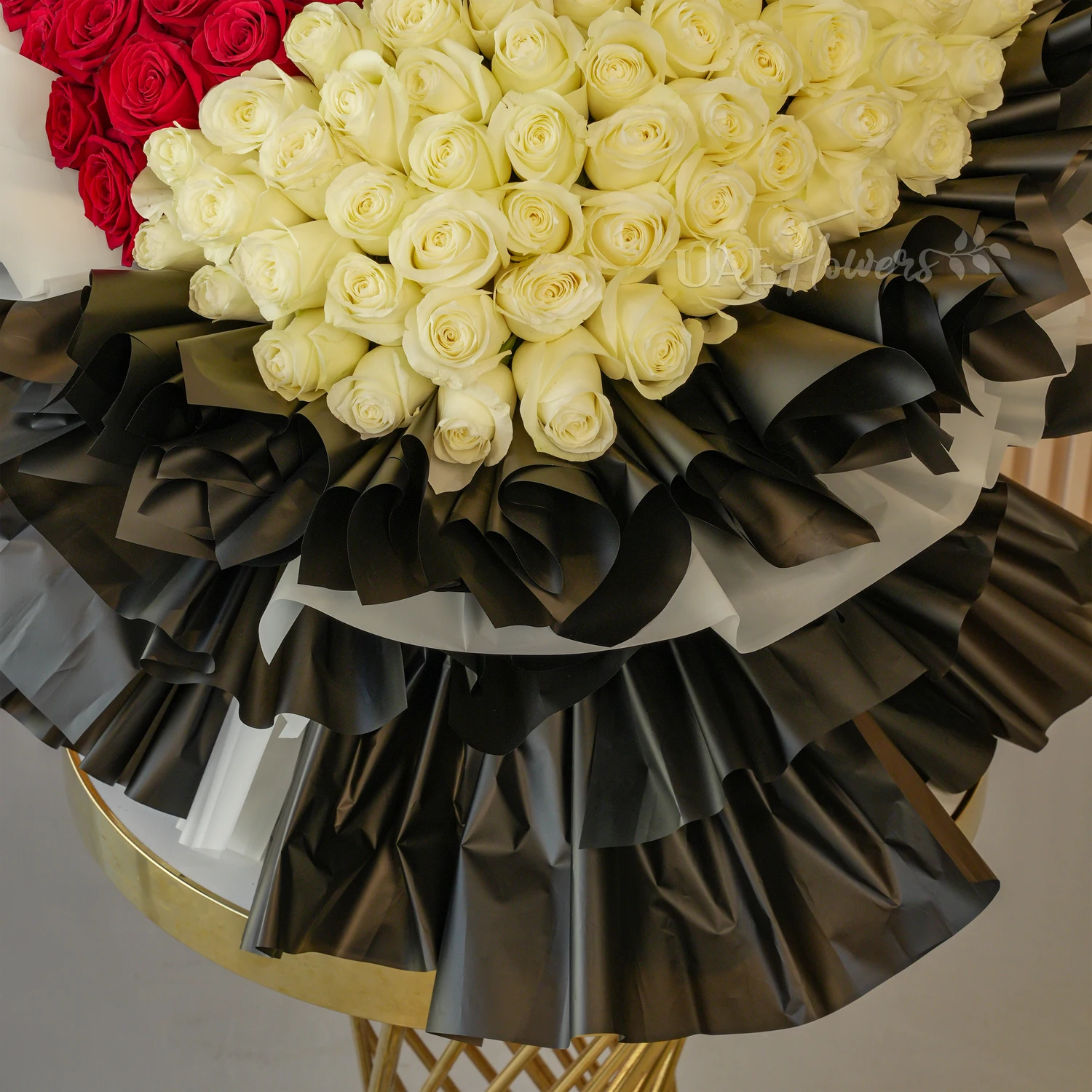 bouquet with 60 red and 60 white roses wrapped in black and white paper packing