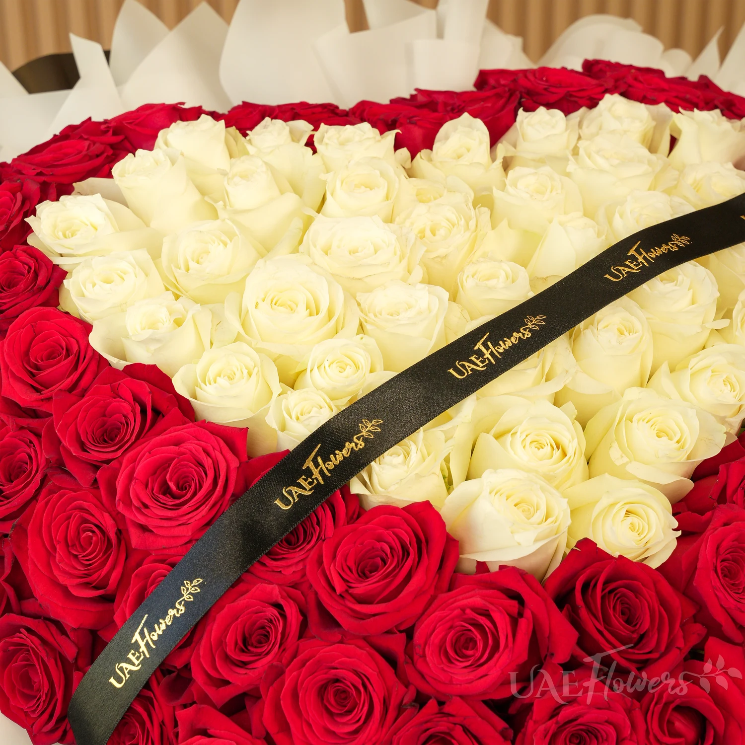 heart-shaped bouquet with 100 red and 50 white roses