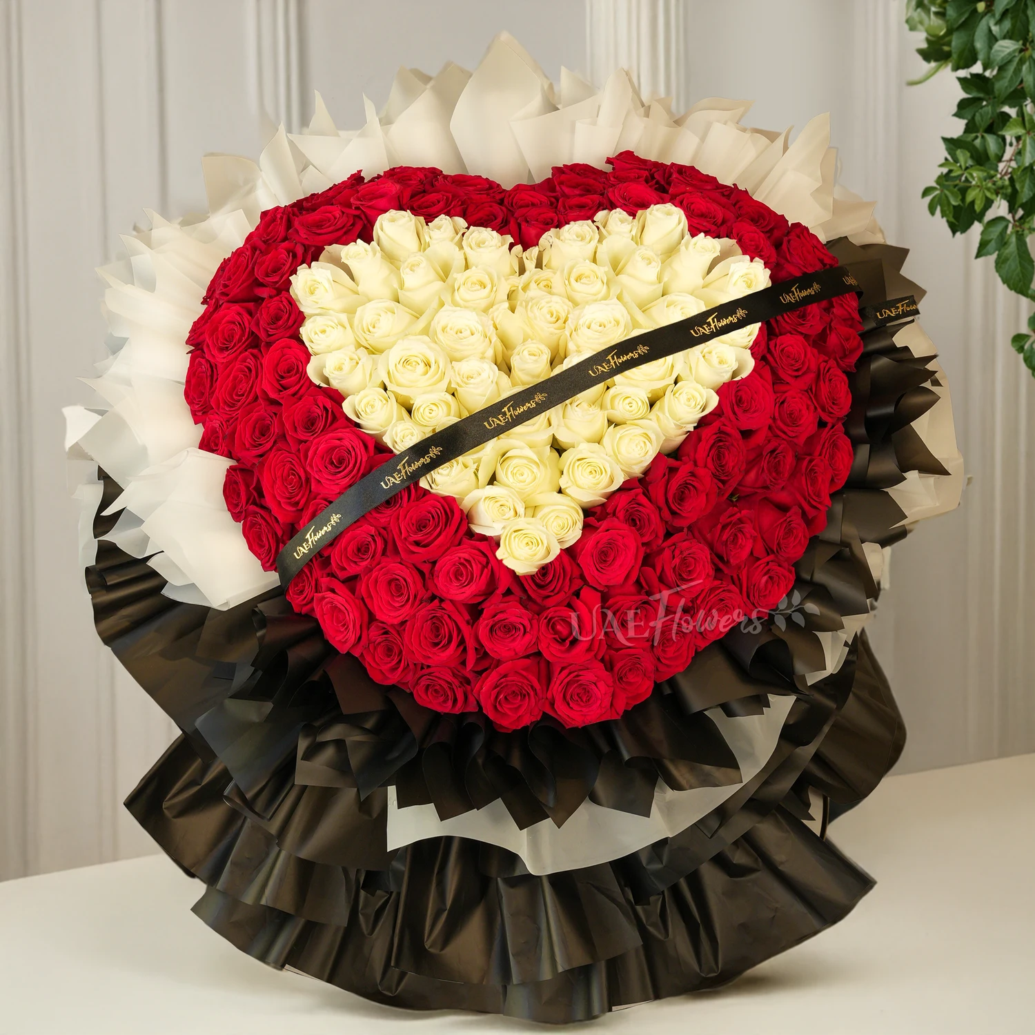 heart-shaped bouquet with 100 red and 50 white roses