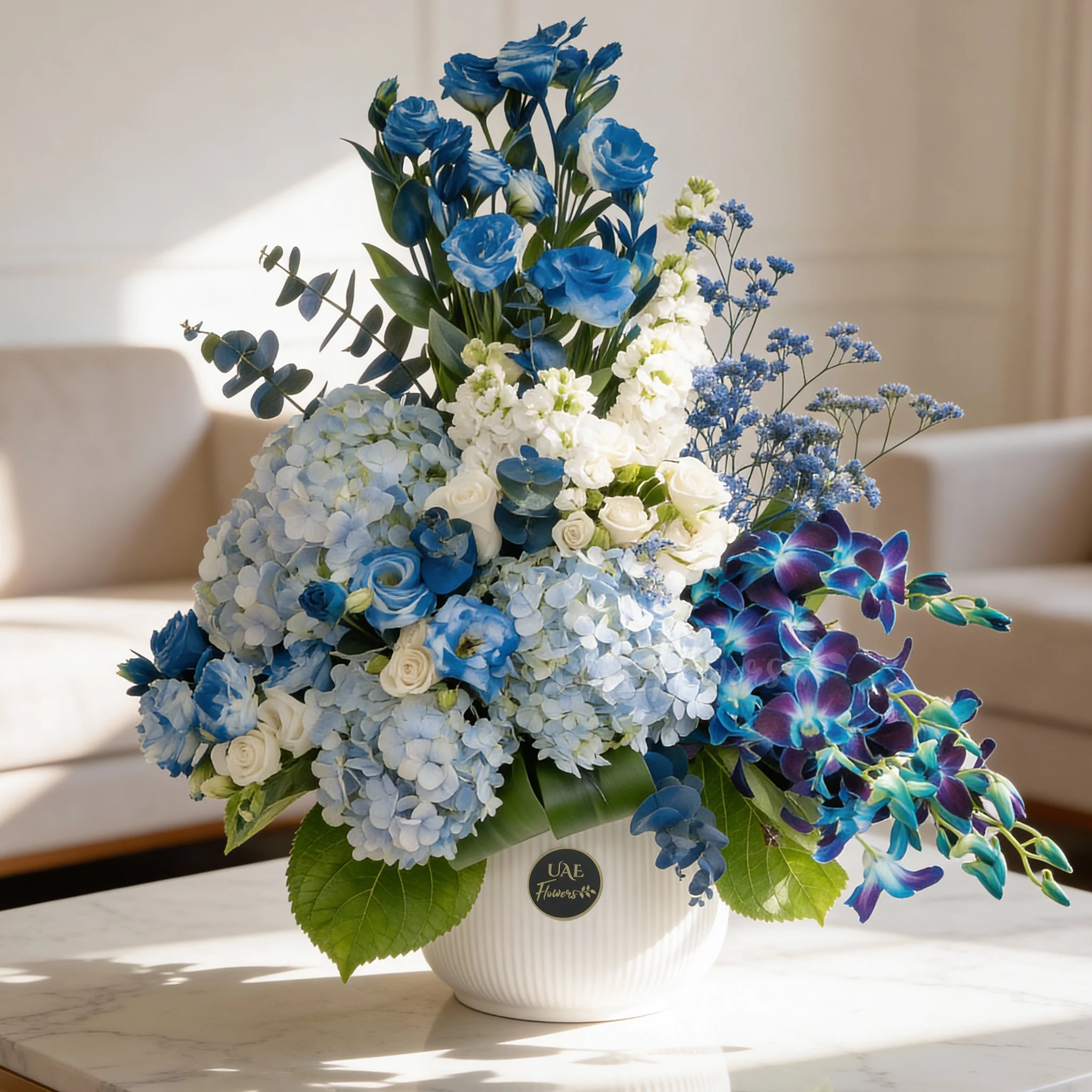 Serene ceramic pot arrangement of white blooms and blue orchids, hydrangeas, and fillers