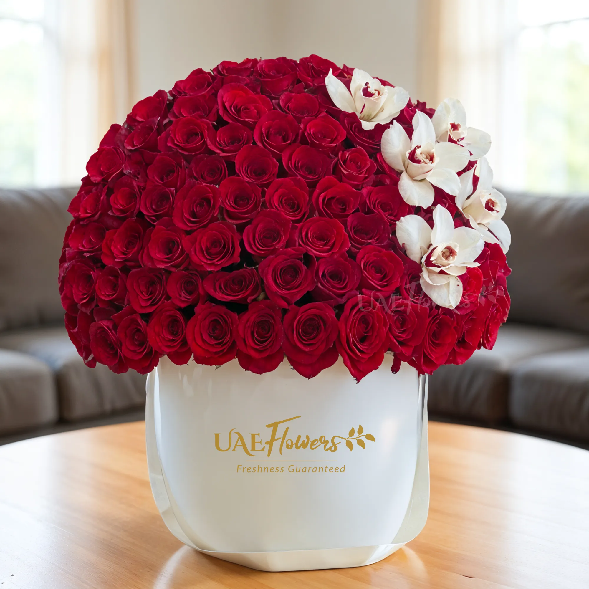 60 red roses and 2 cymbidium orchids beautifully arranged in a round white box