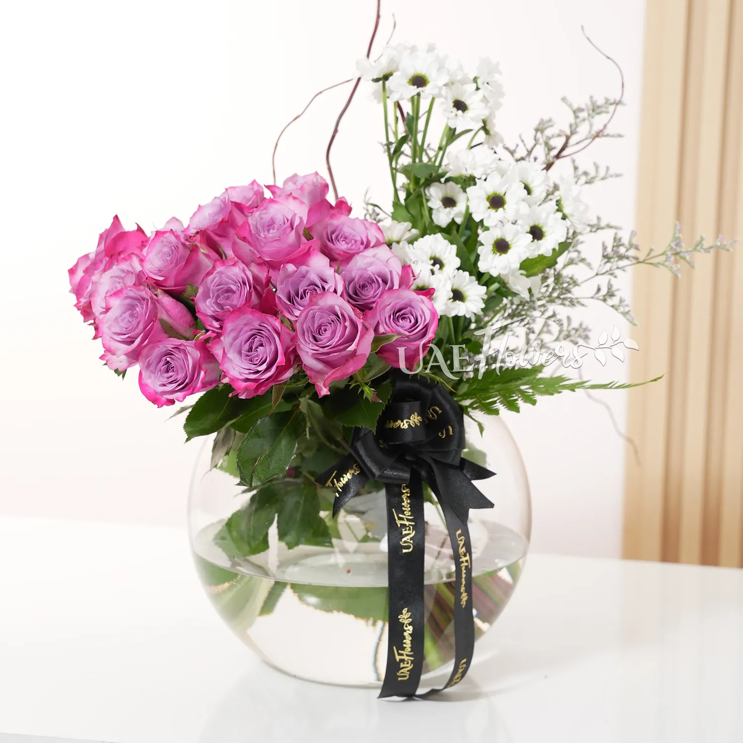 purple roses and white chrysanthemums, accented with lush green fillers