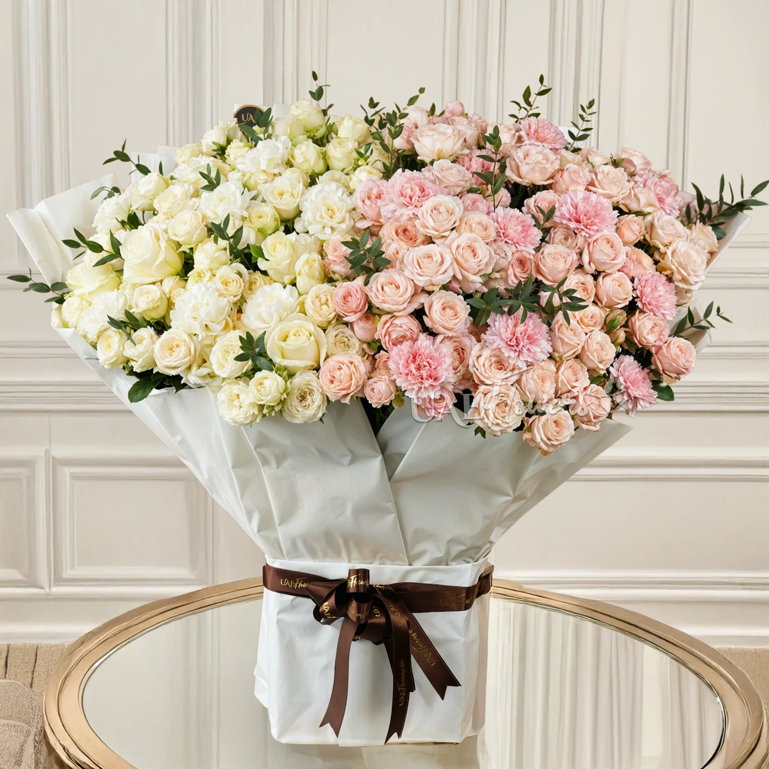 bouquet of spray roses, carnations, and white roses with green fillers.