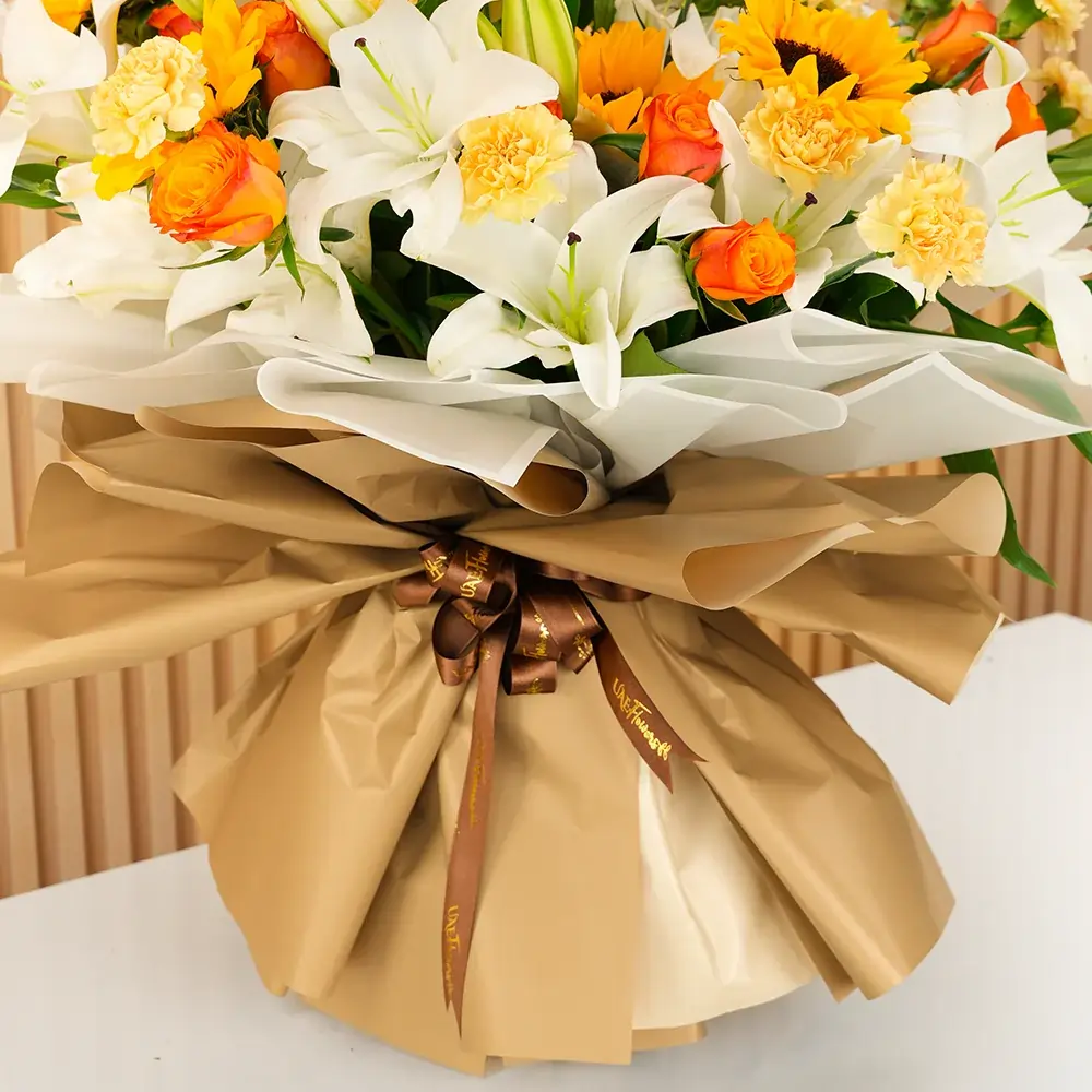 5 white lilies, 5 sunflowers, 10 orange roses, and 15 peach carnations