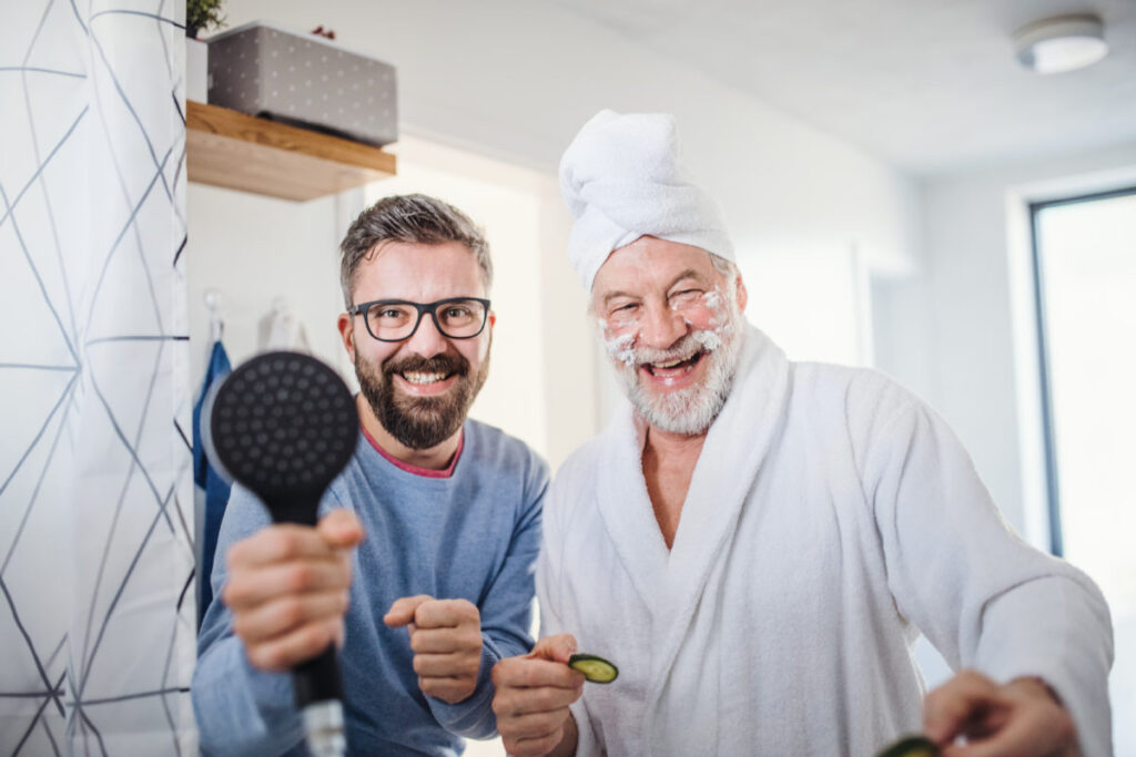 A Man holding an air dryer with an old man in a manicure & pedicure session